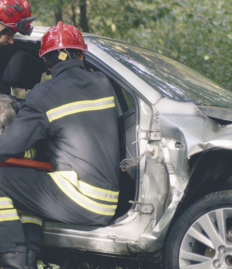 Firefighters freeing a driver from a wrecked car