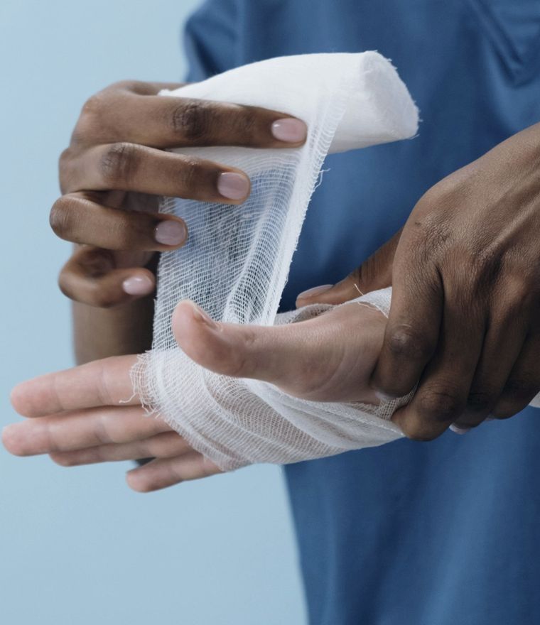 Medical professional wrapping an injured wrist