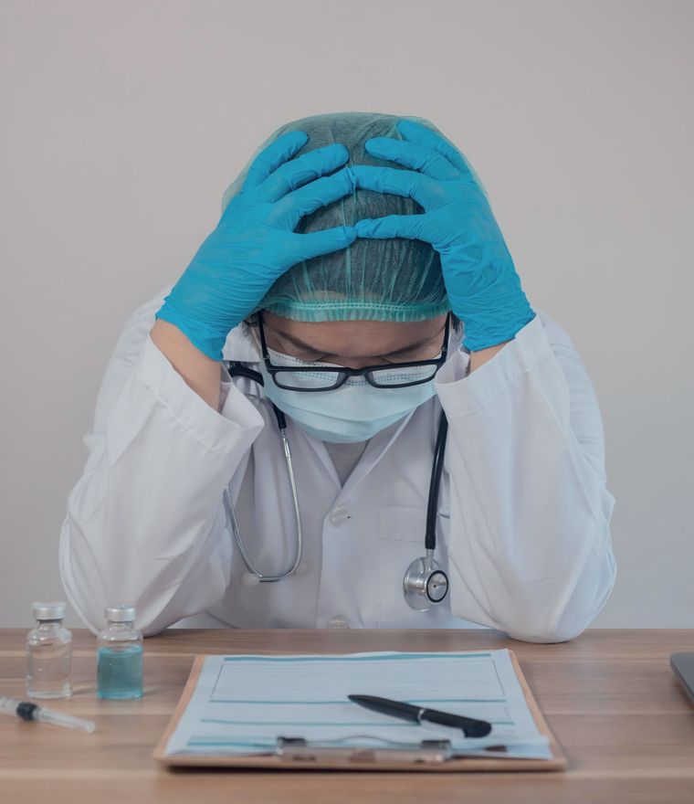 Exhausted healthcare worker at a desk